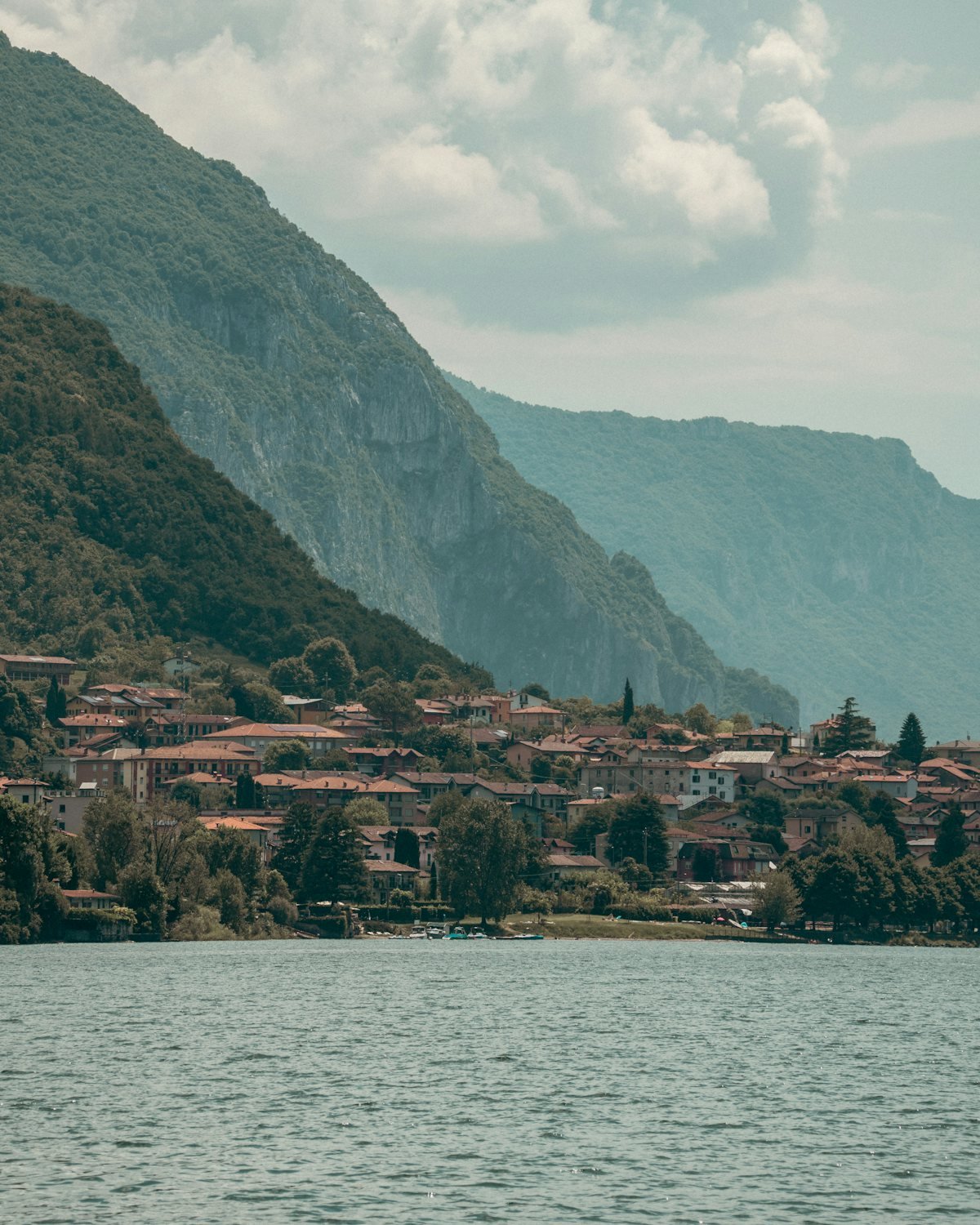 Village between steep mountains and a lake in Europe