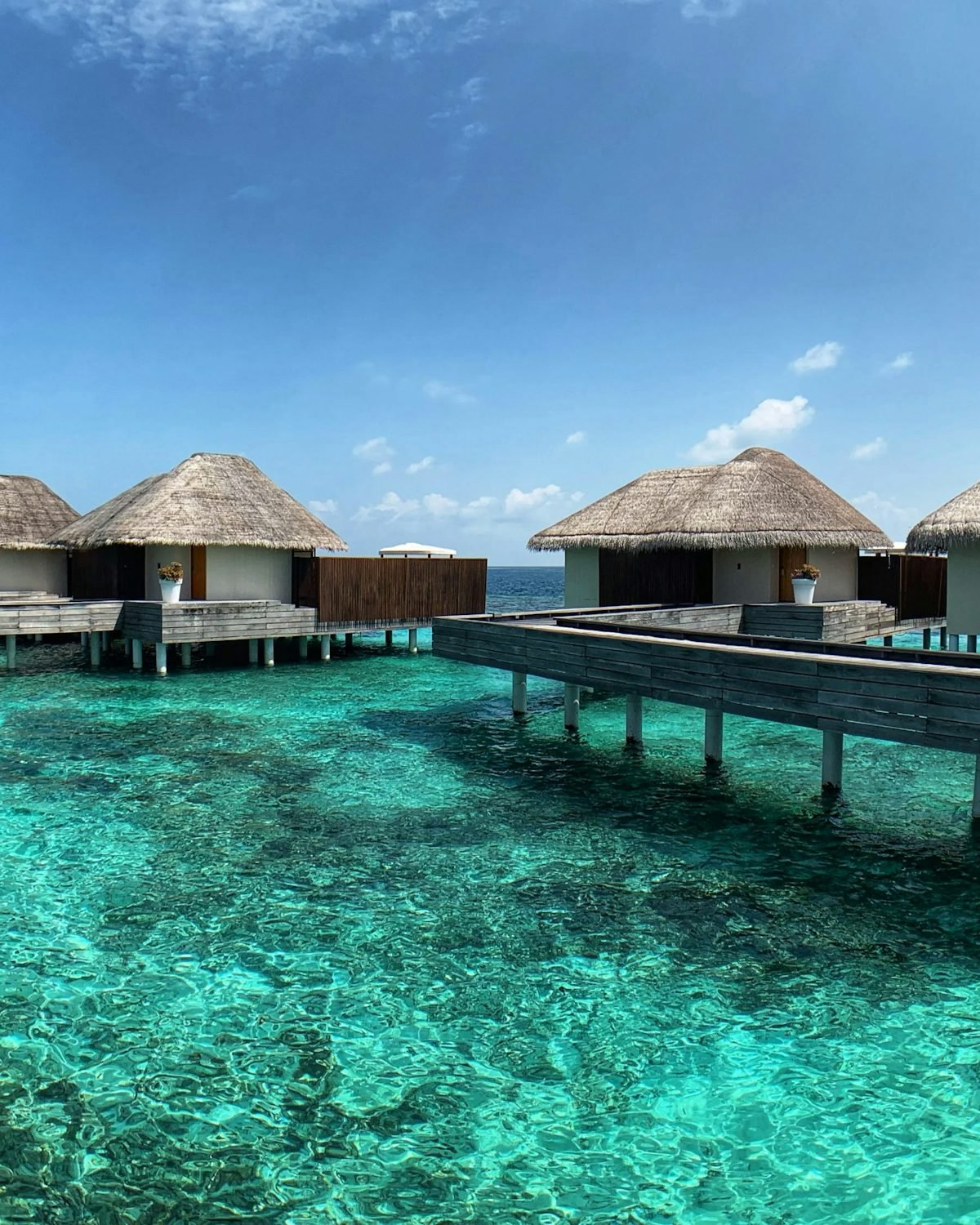 Overwater villas above a turquoise Maldives lagoon