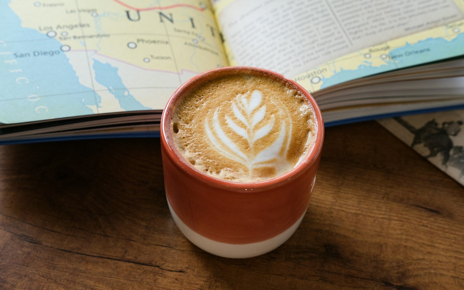 Latte beside an open map, ready for travel planning